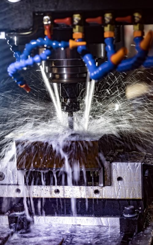 Metalworking CNC milling machine. Cutting metal modern processing technology. Small depth of field. Warning - authentic shooting in challenging conditions. A little bit grain and maybe blurred.